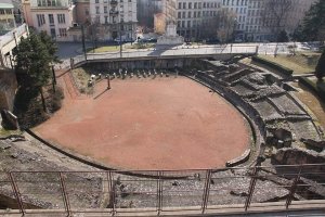 Ruins of the ancient Amphitheatre of the Three Gauls in Lyon showing stone seating and arena outline