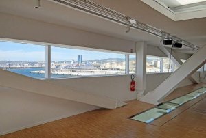 Balcony overlooking port and sea at Villa Méditerranée in Marseille