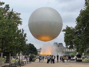 Olympic cauldron lit up at night in Tuileries Garden Paris