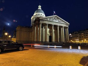 Panthéon illuminated in Paris at night against dark sky
