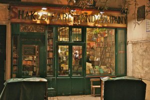 Shakespeare and Company bookshop illuminated at night in Paris