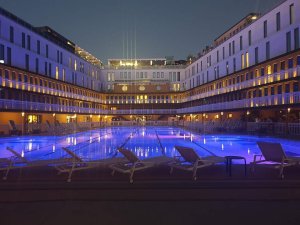 Molitor Pool in Paris illuminated at night with art deco style architecture