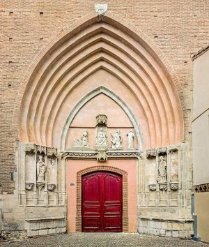 Elaborate entrance portal of Saint Nicolas' Church in Toulouse with detailed stone carvings
