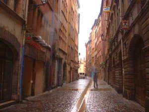 Narrow street Rue Juiverie in Lyon, France with old buildings