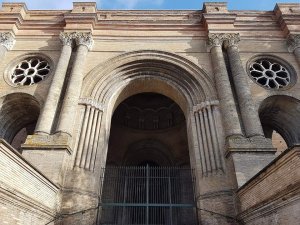 arched stone entrance of Saint-Aubin church in Toulouse with detailed carvings