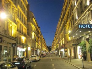 nighttime view of rue Édouard-Herriot street in Lyon with illuminated buildings and streetlights
