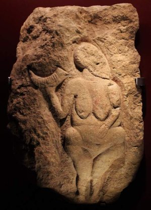 Venus of Laussel Paleolithic carved figure holding a horn