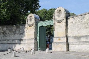 ornate main gate entrance of Père Lachaise Cemetery in Paris