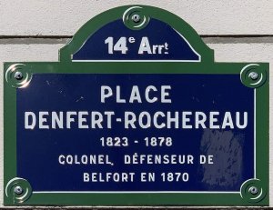Place Denfert-Rochereau name plaque mounted on a wall in Paris