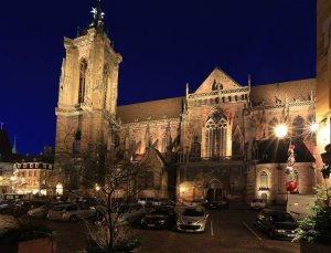 St Martin's Church illuminated at night in Colmar, France with festive lights