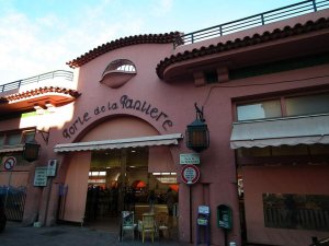Outdoor market stalls with people shopping at Marche Forville central market