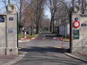 Main entrance gate of Batignolles Cemetery in Paris with surrounding trees