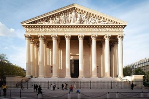 Exterior view of La Madeleine church with classical columns and ornate architecture in Paris