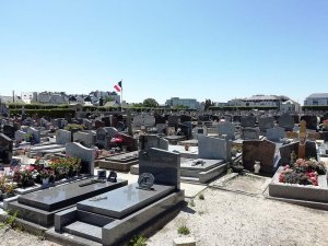 Aerial view showing the layout of Rocabey cemetery with numerous gravestones and green surroundings