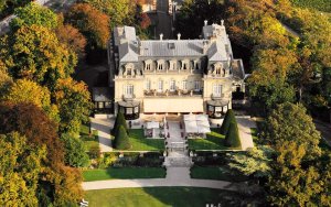 View of Les Crayères château in Reims with classic architecture and manicured gardens