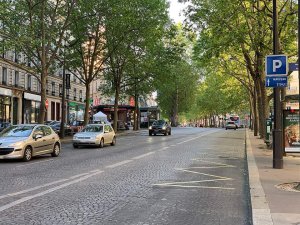 View of Avenue Marceau in Paris with trees lining the street and classic Parisian buildings