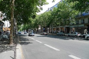View of Boulevard des Capucines street in Paris with buildings and traffic