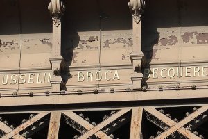 Steel panel on the Eiffel Tower with the name Paul Broca inscribed, flanked by names Jousselin on the left and Becquerel on the right