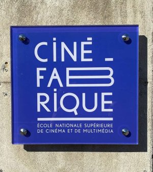 Street sign for CinéFabrique on rue Communieu in Lyon