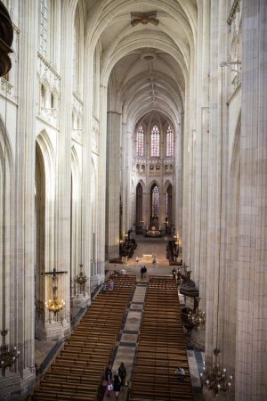 Interior view of the nave in Nantes Cathedral showcasing arches and columns