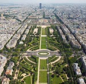 panoramic view of Champ de Mars park from Eiffel Tower with Tour Montparnasse and Les Invalides dome in background
