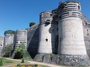 Stone medieval fortress Château d'Angers with fortified walls and towers in France