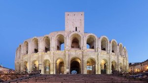 Roman amphitheatre ruins in Arles with partial stone seating and walls