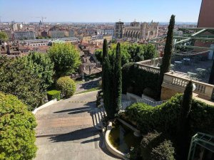 Gardens of Villa Florentine with city of Lyon and its cathedral in the background