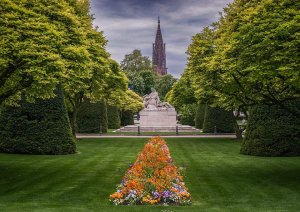 Couple embracing in the green space at Place de la République in Strasbourg