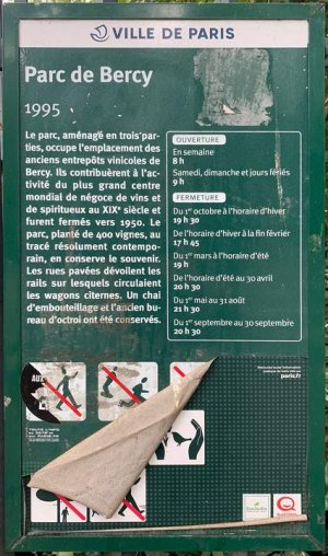 Parc de Bercy park name sign with greenery in the background
