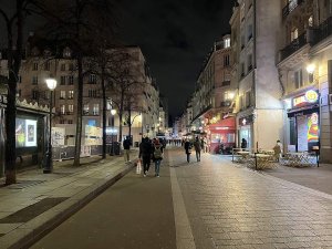 Nighttime view of Rue Saint-Denis street in Paris with illuminated buildings and streetlights