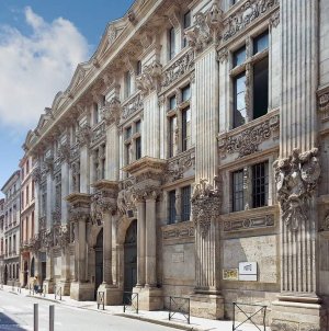 Historic stone facade of Hôtel de Bagis with intricate carved decoration in Toulouse