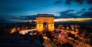 nighttime view of the Arc de Triomphe from Terrasse Publicis with illuminated monument and surrounding streets