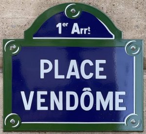 Place Vendôme street name plaque mounted on building wall in Paris