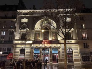 Illuminated Théâtre de la Porte Saint-Martin building at night in Paris