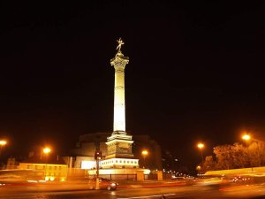 nighttime view of Le Génie statue at Place de la Bastille illuminated against the dark sky