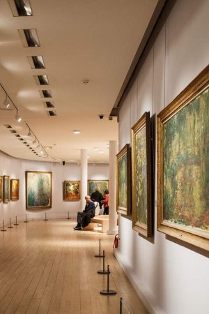Interior view of Musée Marmottan Monet with impressionist paintings displayed and visitors including Minister of Culture Marta Suplicy