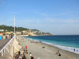 Seaside promenade along the Mediterranean coast in Nice with palm trees and walking paths