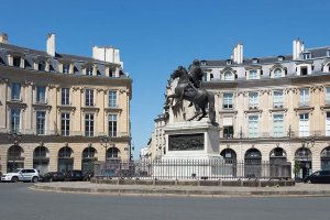 central statue in the Place des Victoires surrounded by historic Parisian buildings