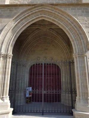 ornate entrance of Saint Vincent Church showing detailed stone carvings in Carcassonne