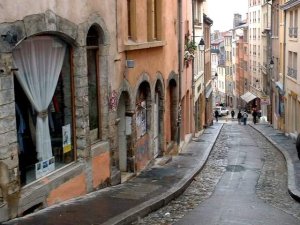 Steep stone stairway ascending between old buildings in Lyon