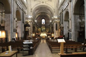 Interior view of Notre-Dame-des-Victoires church showing ornate altar and architectural details
