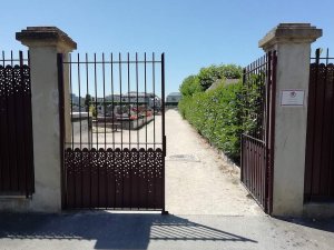 Secondary entrance gate of Rocabey Cemetery with surrounding stone wall