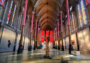 Interior view of St. Anne church in Montpellier showcasing contemporary art installation by nine artists from Sète