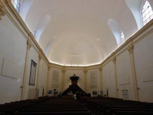 Interior view of Temple du Hâ Protestant church in Bordeaux with wooden pews and decorative altar