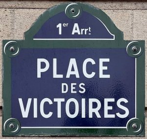 metal plaque showing the name Place des Victoires in Paris