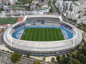 Exterior view of Stade Charléty sports stadium in Paris with surrounding urban area