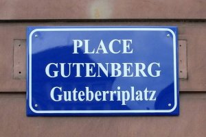 blue metal street sign with white letters reading Place Gutenberg in Strasbourg