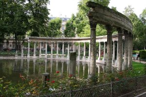 winding paths and statues surrounded by lush trees in Parc Monceau park in Paris