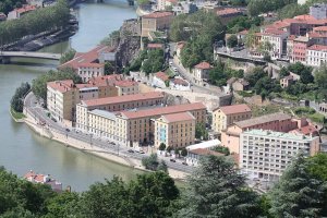 View from rooftops of Basilica of Notre-Dame de Fourvière overlooking Saône river and historic Lyon buildings
